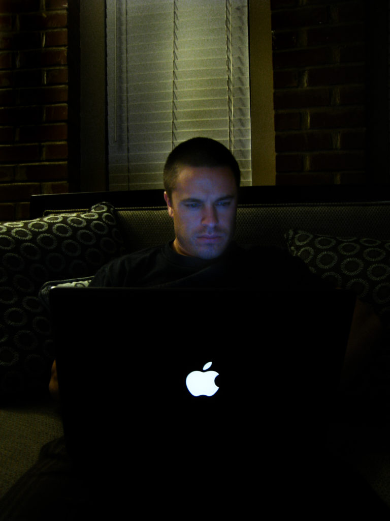 Carl in front of an Apple laptop